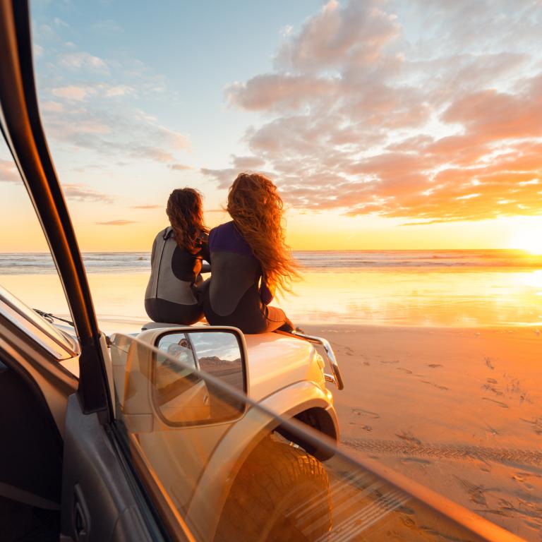 Sitting on car with sunset